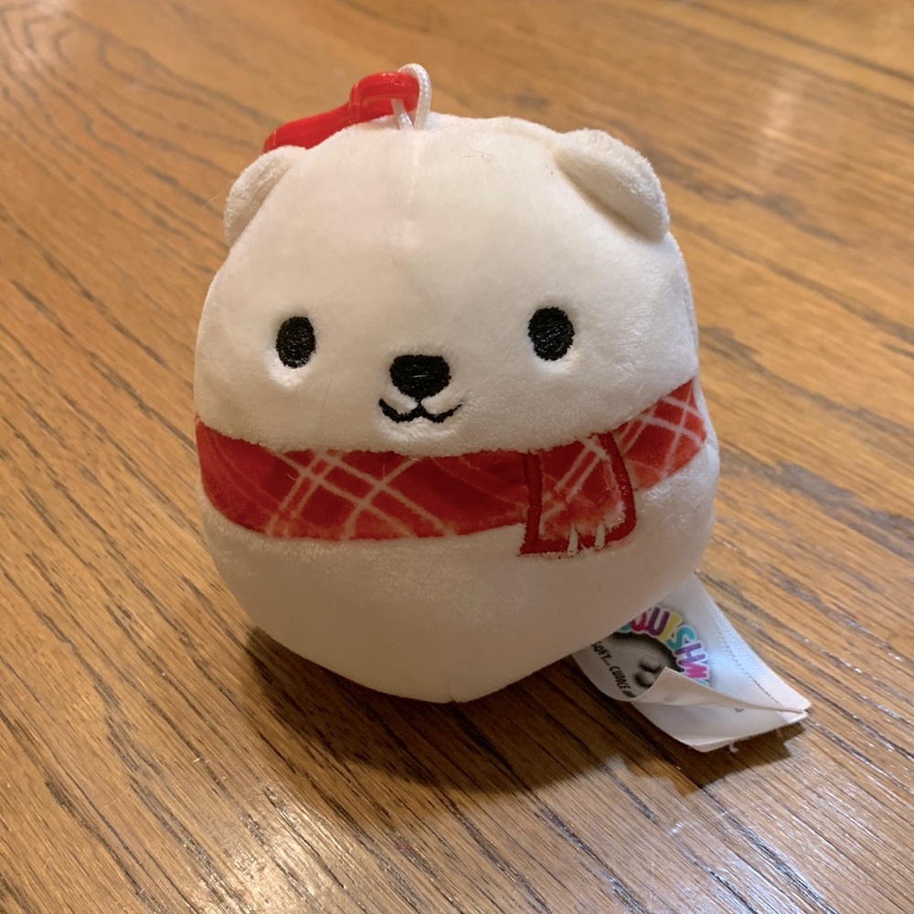 Brooke the polar bear with a scarf!!! She is a clip on Squishmellow by Kellytoy.